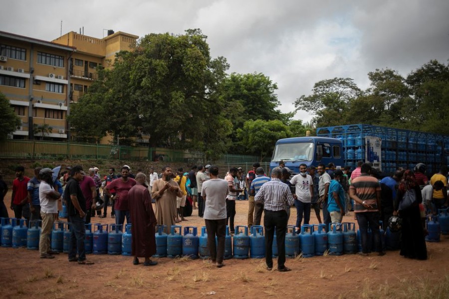 People stand next to their empty cylinders as they wait in a queue to buy domestic cooking gas, amid the country's economic crisis, in Colombo, Sri Lanka on July 23, 2022 — Reuters photo