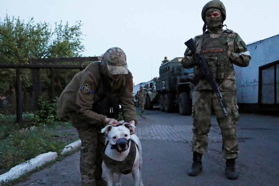 A Ukrainian detainee walking a dog at Olenivka prison –Reuters file photo