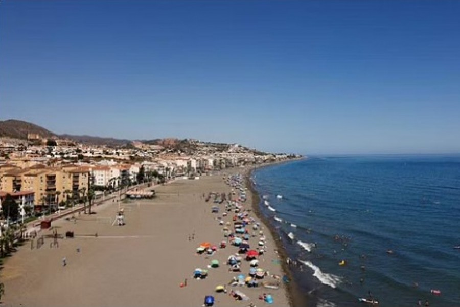 People cool off at the Mediterranean Sea on a beach on a hot summer day in Rincon de la Victoria, near Malaga, Spain, July 9, 2022. REUTERS/Jon Nazca