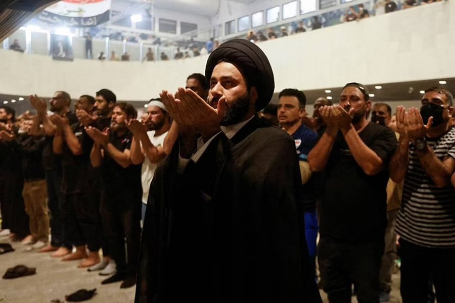 Supporters of Iraqi Shia cleric Moqtada al-Sadr pray during a protest against corruption, inside the Parliament, in Baghdad, Iraq July 30, 2022.REUTERS/Ahmed Saad