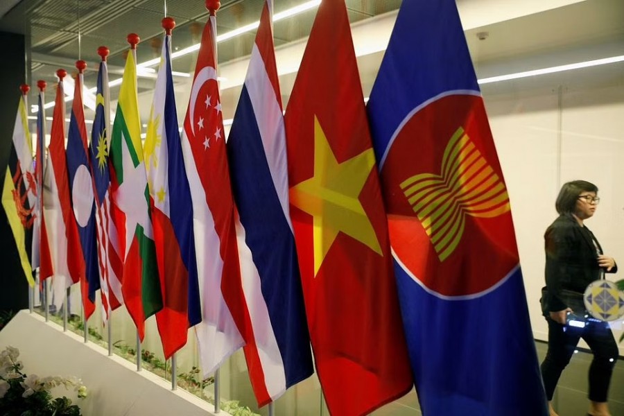 A woman passes ASEAN Summit flags at Suntec Convention Centre in Singapore, November 11, 2018. Reuters