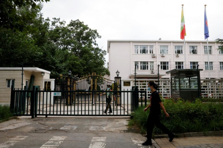 A man walks past a paramilitary police officer keeping watch outside the Myanmar embassy in Beijing, China on August 8, 2022 — Reuters photo