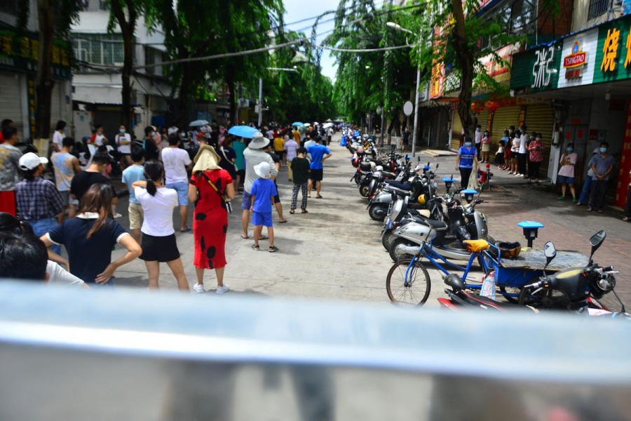 People line up at a nucleic acid testing site amid lockdown measures to curb the coronavirus disease (COVID-19) outbreak in Sanya, Hainan province, China August 6, 2022. China Daily via REUTERS