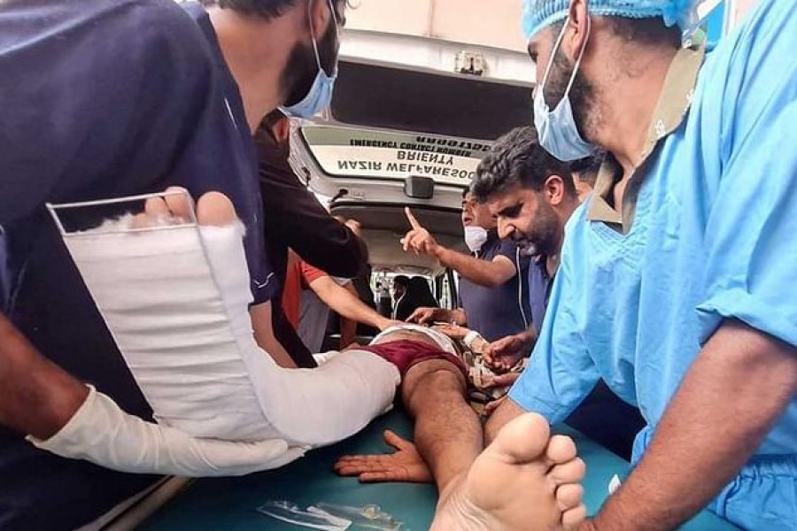 A member of Indo-Tibetan Border Police (ITBP), who was injured in a bus accident, is rushed towards an ambulance after he was given first aid and was referred to other hospital for further treatment, in south Kashmir's Anantnag district August 16, 2022. REUTERS/Stringer