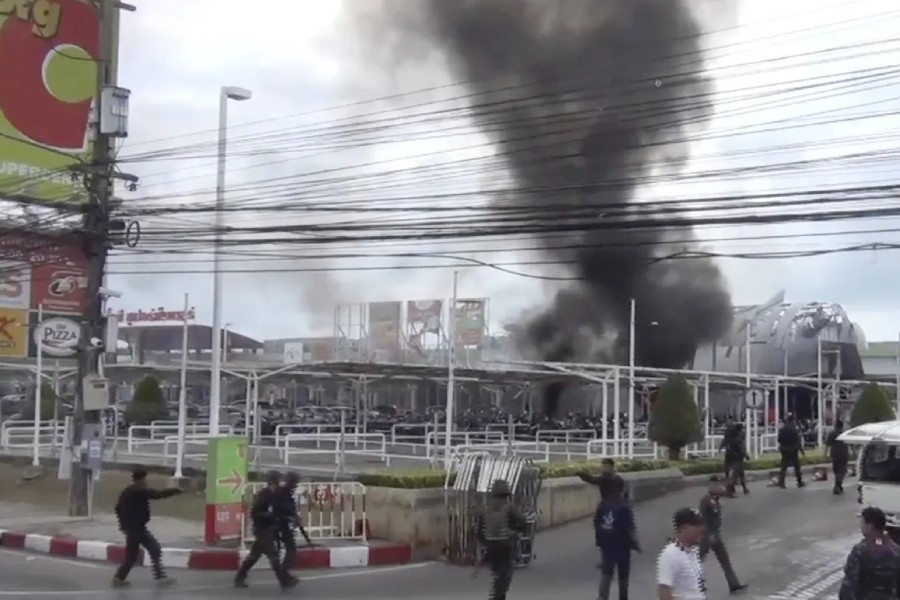 Smoke rises from an exploded vehicle outside a popular shopping center in Pattani province, southern Thailand, in 2017. The area has experienced a decades-long insurgency - AP/File