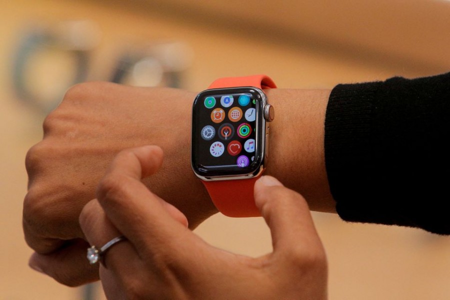 An Apple Store employee shows the Series 5 Apple Watch during the preview of the redesigned and reimagined Apple Fifth Avenue store in New York, U.S., September 19, 2019. REUTERS/Brendan McDermid