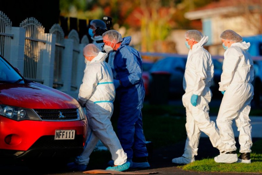 New Zealand police investigators in Auckland on August 11, 2022, after bodies were discovered in two suitcases [Dean Purcell/New Zealand Herald/AP]