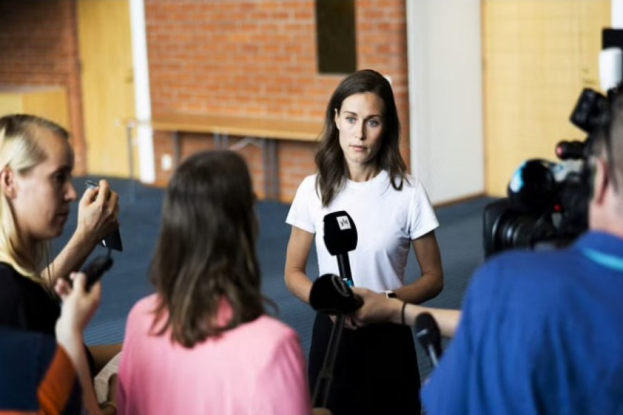 Finland's Prime Minister Sanna Marin speaks with members of the media in Kuopio, Finland Aug 18, 2022. Matias Honkamaa/Lehtikuva/REUTERS