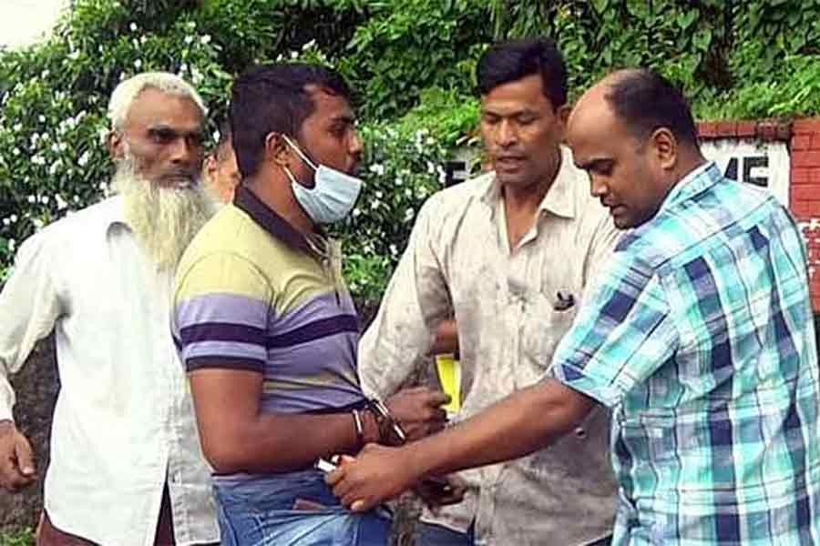 A policeman was caught on camera putting narcotics in the pocket of a pedestrian. Photo: Ekattor TV