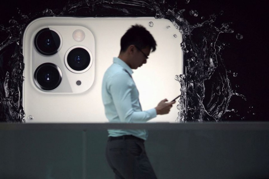 A man walks next to an advertisement for Apple's new iPhone 11 Pro at the Apple Store in IFC, Central district, Hong Kong, China on October 10, 2019 — Reuters/Files