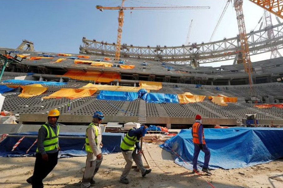 Workers are seen inside the Lusail stadium which is under construction for the upcoming 2022 Fifa soccer World Cup during a stadium tour in Doha, Qatar, December 20, 2019. REUTERS/Kai Pfaffenbach