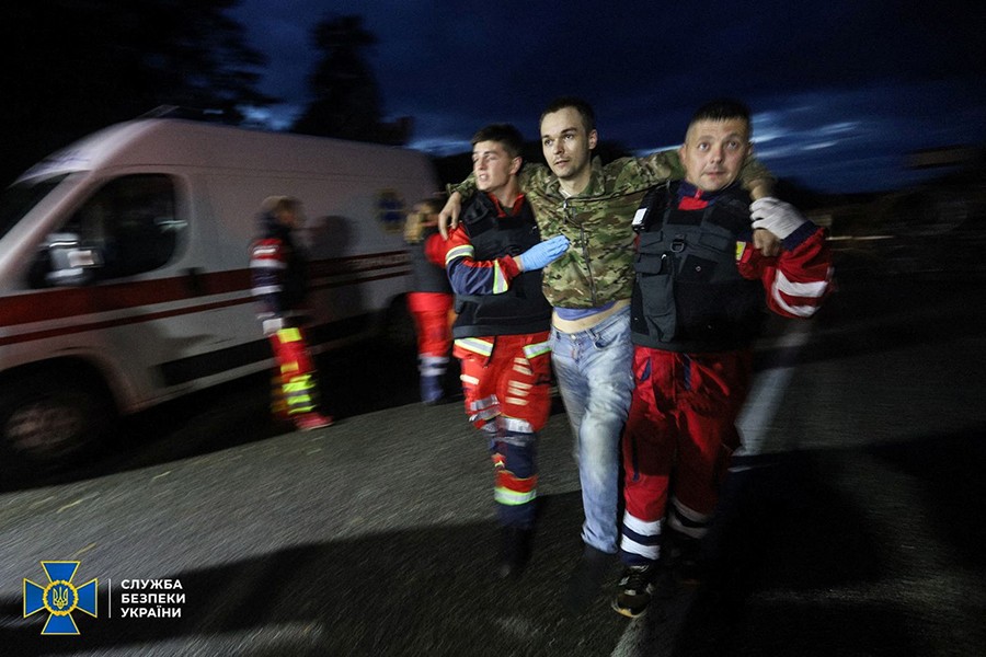 Paramedics help Ukrainian prisoner of war (POW) after a swapping, amid Russia's attack on Ukraine, in Chernihiv region, Ukraine, in this handout picture released on September 22, 2022 — Press Service of the State Security Service of Ukraine/Handout via REUTERS