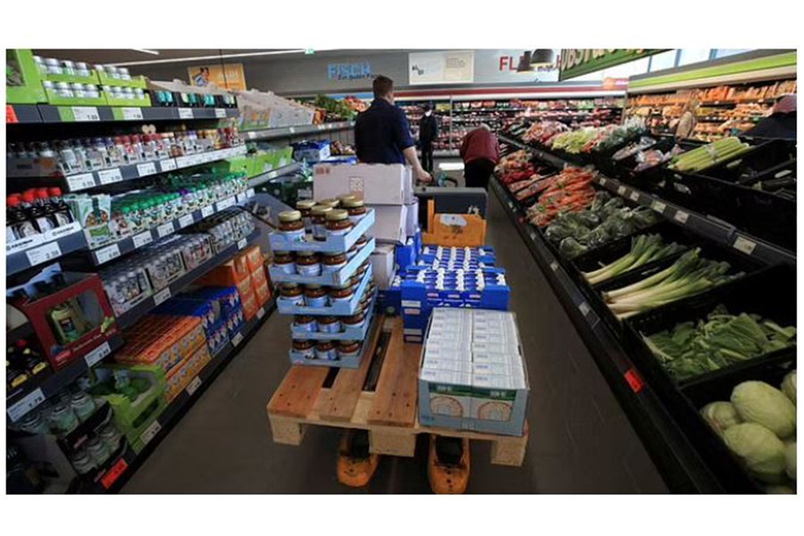 An employee of German food discounter ALDI Nord in EssenGermany, March 5, 2021. REUTERS