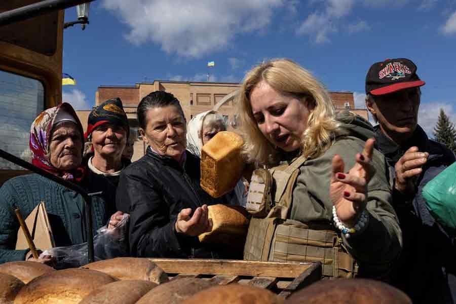 Locals waiting in line for bread, candles and food provided by aid workers as there is no electricity in Balakliia, recently liberated by Ukrainian Armed Forces, in Kharkiv region of Ukraine on September 21 this year –Reuters file photo