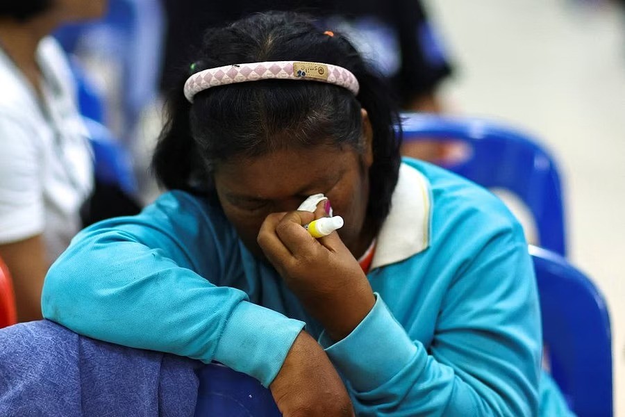 A woman reacts as people gather outside a day care center which was the scene of a mass shooting, in the town of Uthai Sawan, around 500 km northeast of Bangkok in the province of Nong Bua Lam Phu, Thailand October 6, 2022. REUTERS