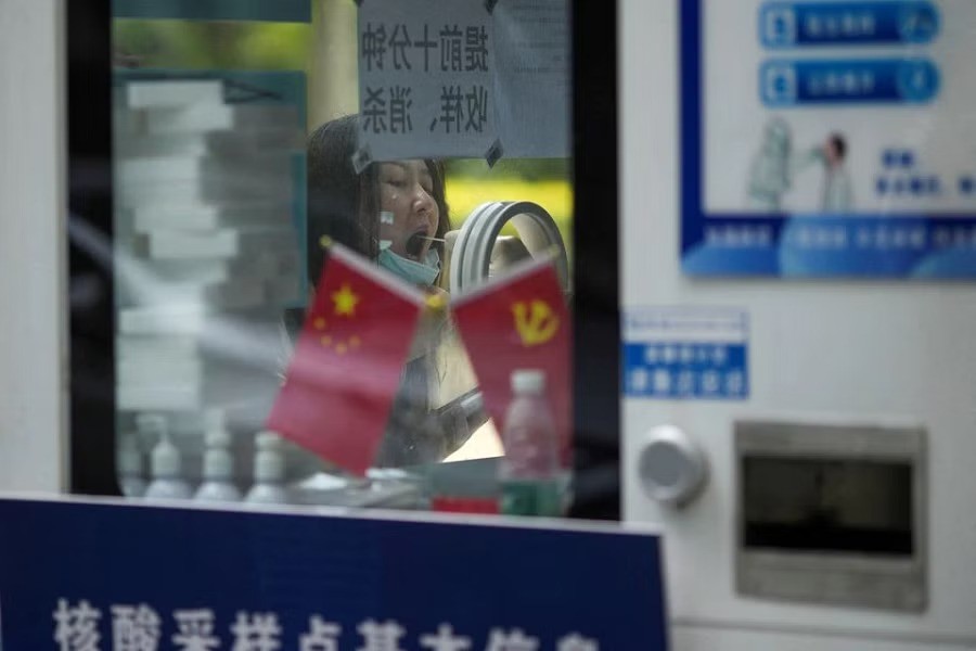 A woman gets tested for the coronavirus disease (COVID-19) at a nucleic acid testing site, following the coronavirus disease outbreak, in Shanghai, China, September 23, 2022. REUTERS