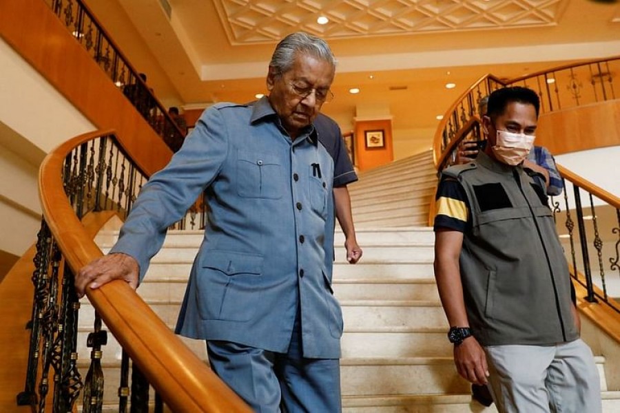 Former Malaysian Prime Minister Mahathir Mohamad walks down the staircases at his office after attending a news conference at Putrajaya, Malaysia Oct 11, 2022. REUTERS