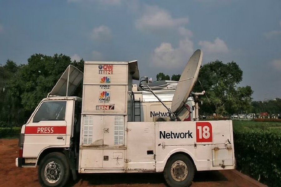 A van of media group Network18 is parked outside the Indian parliament in New Delhi Jul 16, 2014. REUTERS