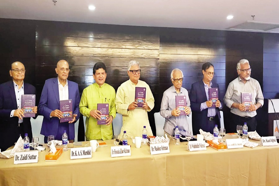 From left, Dr Zaidi Sattar, Dr K A S Murshid, Dr Hossain Zillur Rahman, Prime Minister's Adviser for Economic Affairs Dr Mashiur Rahman, Professor Dr Wahiduddin Mahmud, Dr Ahsan H Mansur and Dr Kazi Iqbal hold a copy of a book, titled 'The Odds Revisited - The Political Economy of Development of Bangladesh', during its launch at a city hotel recently — PRI photo