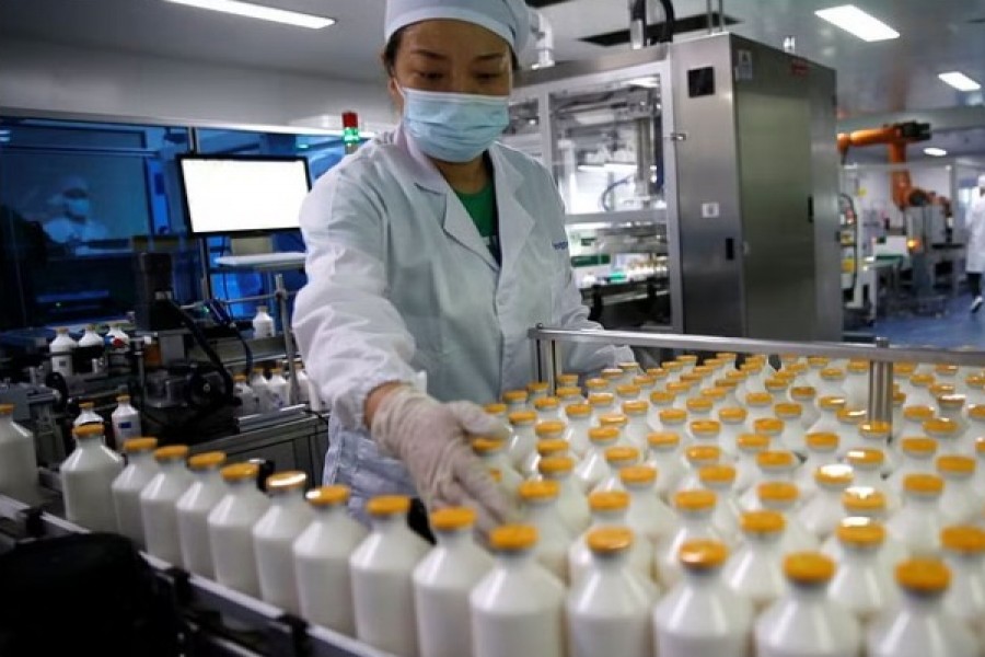 An employee works at a packaging line for chicken vaccine at Ringpu Biotech in Tianjin, China, September 8, 2021. REUTERS