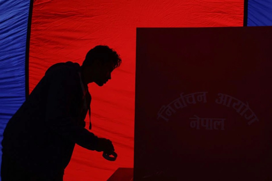 An official from the election commission works to set up a voting booth at the polling station a day ahead of the general elections, in Bhaktapur, Nepal November 19, 2022. REUTERS/Navesh Chitrakar