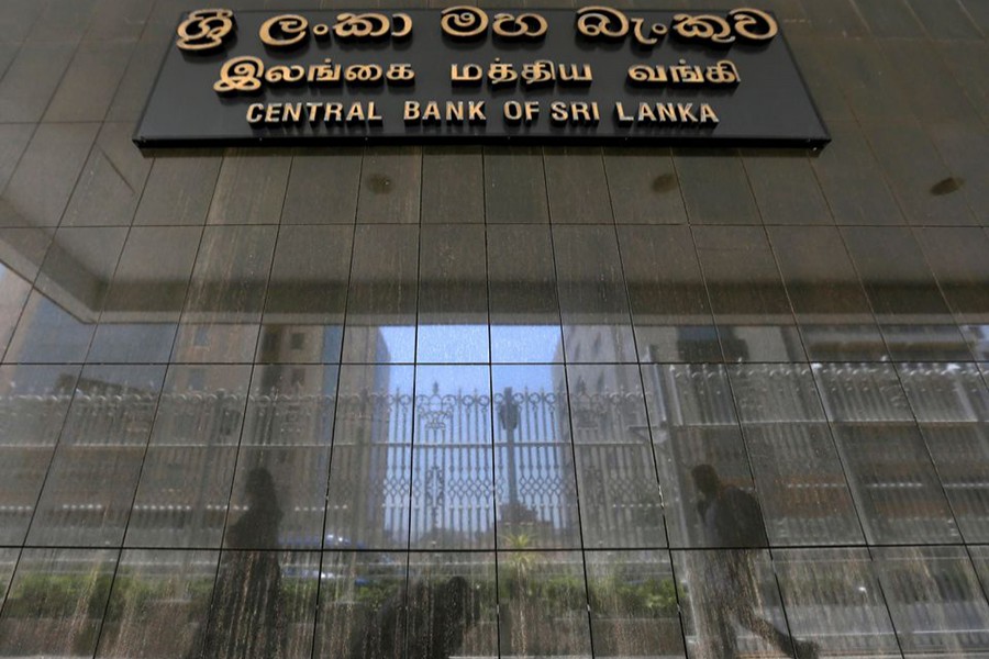 People walk past the main entrance of the Sri Lanka's Central Bank in Colombo, Sri Lanka on March 24, 2017 — Reuters/Files