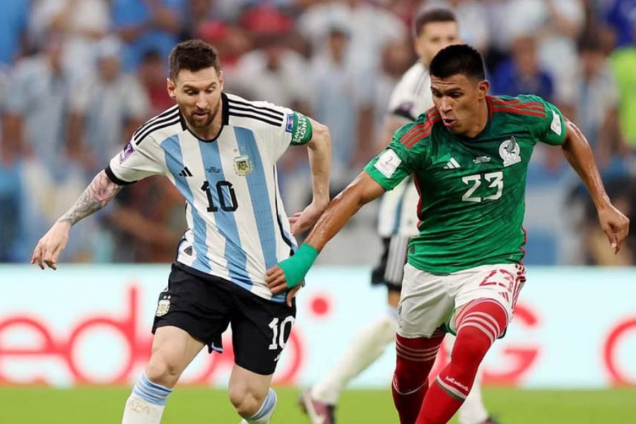 Football - FIFA World Cup Qatar 2022 - Group C - Argentina v Mexico - Lusail Stadium, Lusail, Qatar - November 26, 2022 Argentina's Lionel Messi in action with Mexico's Jesus Gallardo. Reuters