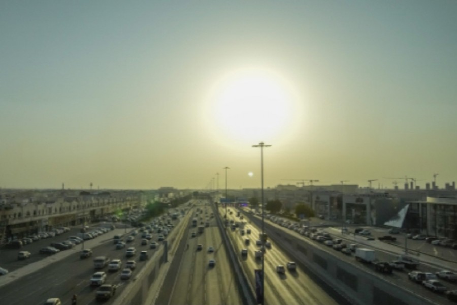 Cars drive at a highway as the sun sets in Doha, Qatar, Monday, Nov. 14, 2022. Qatar unveiled a plan last October to cut its emissions by a quarter by 2030. Then, Russia invaded Ukraine and made the Persian Gulf nation's liquid natural gas only more sought after. Demand for fossil fuels has brought immense wealth to Qatar, but in the coming decades, it could also make one of the world's hottest places unlivable. (AP Photo/Hassan Ammar)