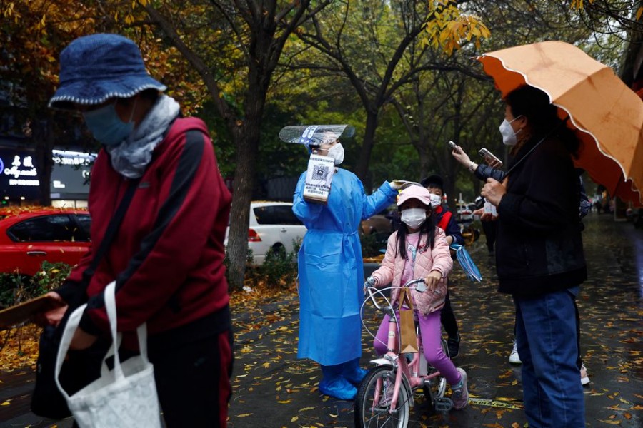 An elderly person scans a QR code at a nucleic acid testing site for the coronavirus disease (COVID-19), in Beijing, China November 11, 2022. REUTERS/Tingshu Wang