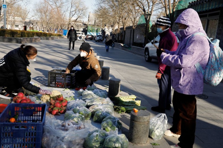 People shop for vegetables at a street stall amid the coronavirus disease (Covid-19) outbreak in Beijing, China on December 6, 2022 — Reuters photo