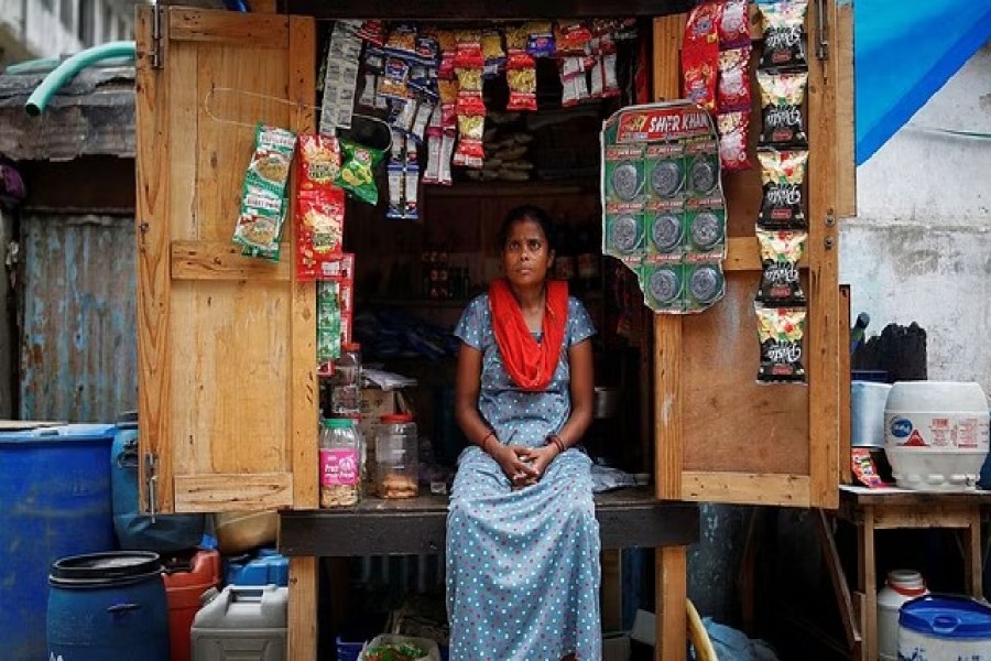 Chineya Devi, 32, who lost her job in a packaging firm, sits inside her roadside stall, near her house, in New Delhi, India, Jul 26, 2021.REUTERS