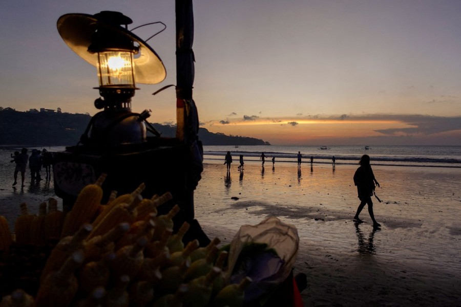 People enjoy the beach during sunset in Jimbaran, Bali, Indonesia, September 2, 2022. REUTERS/Willy Kurniawan