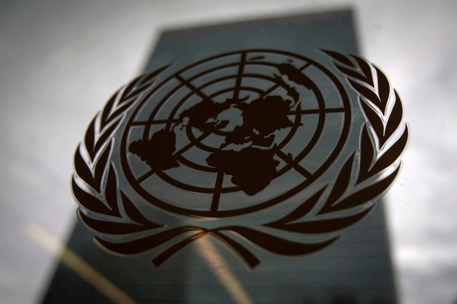 The United Nations headquarters building is pictured though a window with the UN logo in the foreground in the Manhattan borough of New York on August 15, 2014 — Reuters/Files