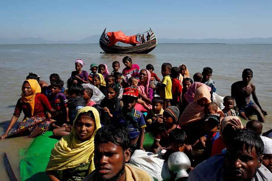 Rohingya refugees sitting on a makeshift boat at Shah Porir Dwip near Cox's Bazar of Bangladesh on November 9 in 2017 as they get interrogated by the Border Guard Bangladesh after crossing the Bangladesh-Myanmar border –Reuters file photo