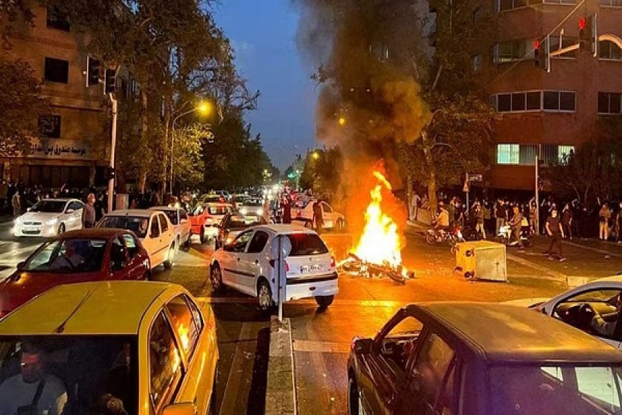 A police motorcycle burns during a protest over the death of Mahsa Amini, a woman who died after being arrested by the Islamic republic's "morality police", in Tehran, Iran September 19, 2022. WANA (West Asia News Agency) via REUTERS