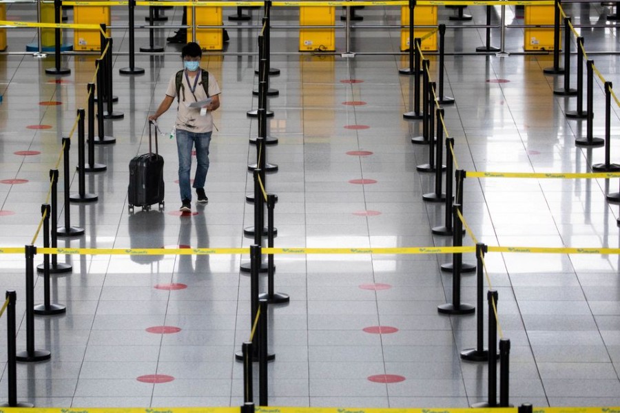 A passenger wearing a face mask and face shield for protection against the coronavirus disease (COVID-19) walks towards a counter in the Ninoy Aquino International Airport in Paranaque, Metro Manila, Philippines on January 14, 2021 — Reuters/Files