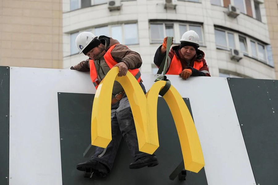 Workers dismantle the McDonald's Golden Arches while removing the logo signage from a restaurant of McDonald's in Almaty, Kazakhstan on January 6, 2023 — Reuters photo