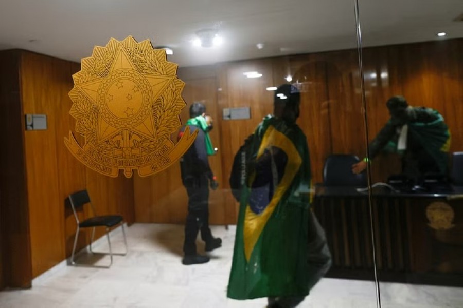 Supporters of Brazil's former President Jair Bolsonaro vandalize the interior of Planalto Palace in front of President Luiz Inacio Lula da Silva's office during a demonstration against President Luiz Inacio Lula da Silva, in Brasilia, Brazil, January 8, 2023. REUTERS