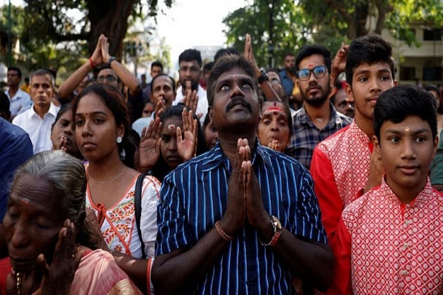 Devotees pray during the harvest festival of Thai Pongal, a thanksgiving ceremony in which the farmers thank the spirits of nature, the sun and the farm animals for their assistance in providing a successful harvest, at a Hindu temple in Colombo, Sri Lanka, Jan 15, 2023. REUTERS