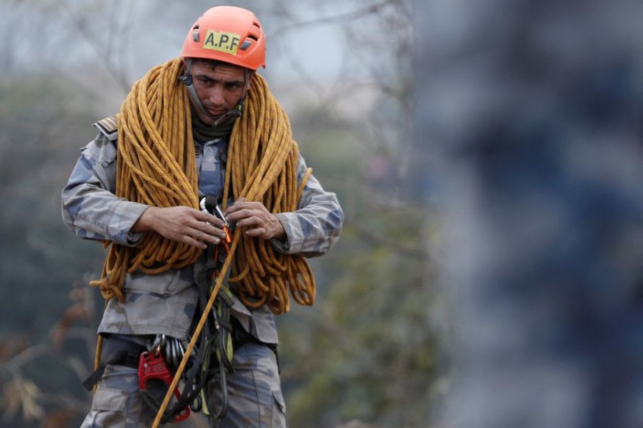 A member of Arm Police Force works at a crash site of a Yeti Airlines operated aircraft, in Pokhara, Nepal January 16, 2023. REUTERS/Rohit Giri NO RESALES. NO ARCHIVES