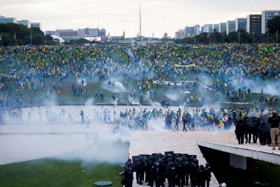 Supporters of Brazil's former President Jair Bolsonaro demonstrate against President Luiz Inacio Lula da Silva as security forces operate, outside Brazil’s National Congress in Brasilia, Brazil, January 8, 2023. REUTERS/Adriano Machado