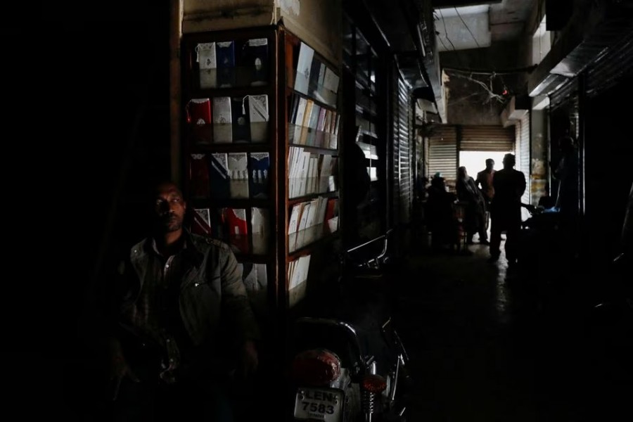 A man sits outside his shop during a country-wide power breakdown in Karachi, Pakistan on January 23, 2023 — Reuters photo