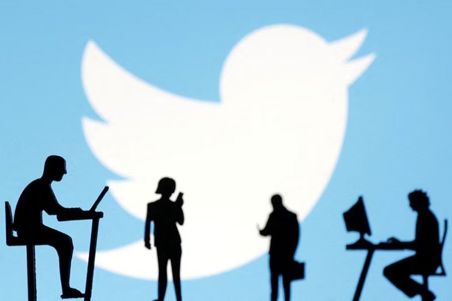 Figurines with smartphones and computers are seen in front of the Twitter logo in this illustration on November 28, 2022 — Reuters/Files