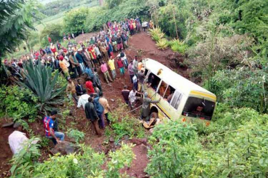 Residents gather at the scene of an accident that killed schoolchildren, teachers and a minibus driver at the Rhota village along the Arusha-Karatu highway in Tanzania's northern tourist region of Arusha on Saturday. – Reuters photo