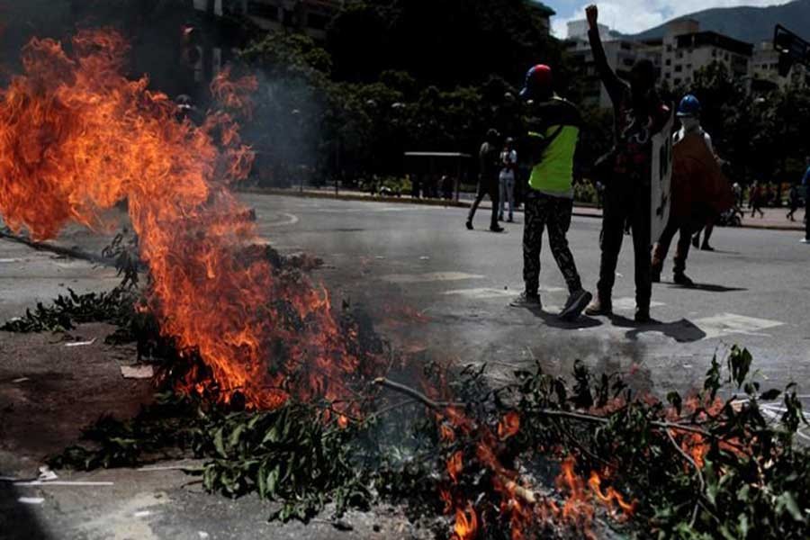 Demonstrators block a street at a rally against Venezuela's President Nicolas Maduro's government in Caracas, Venezuela on Wednesday.