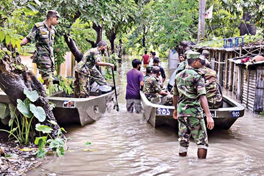 A team of army jawans evacuating people from a flood-affected village in Dinajpur on Sunday.— bdnews24.com