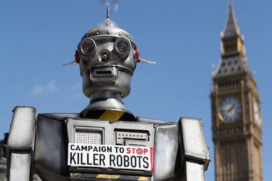 A robot is pictured in front of the Houses of Parliament and Westminster Abbey as part of the Campaign to Stop Killer Robots in London on April 23, 2013. - Collected