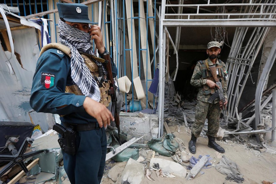 Afghan security forces keep watch at the site of a suicide bomb attack in Kabul, Afghanistan on Tuesday.