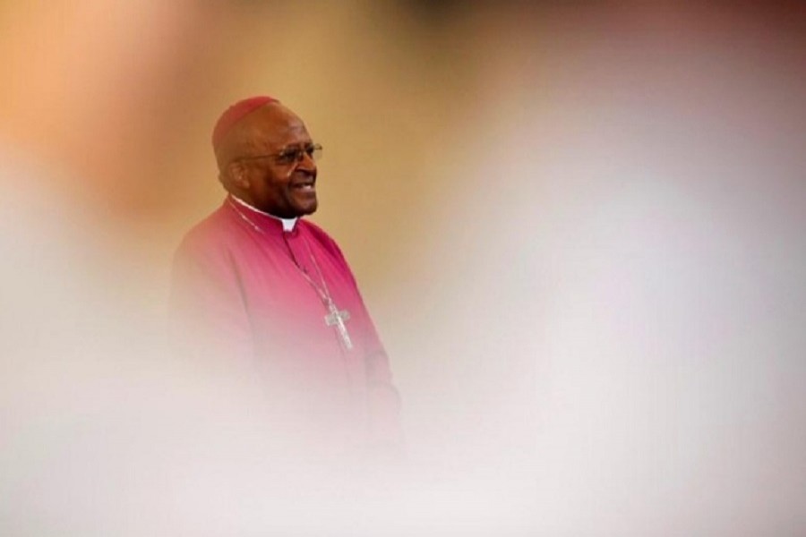 Archbishop Desmond Tutu is seen through crowds during a visit to a youth centre in Masiphelele township near Cape Town, South Africa, July 8, 2011. Reuters
