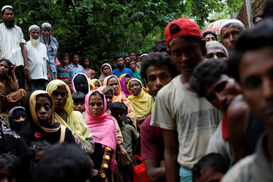 Rohingya refugees wait for food near the Kutupalong refugee camp in Bangladesh on Wednesday last after crossing the Myanmar border. - Reuters photo